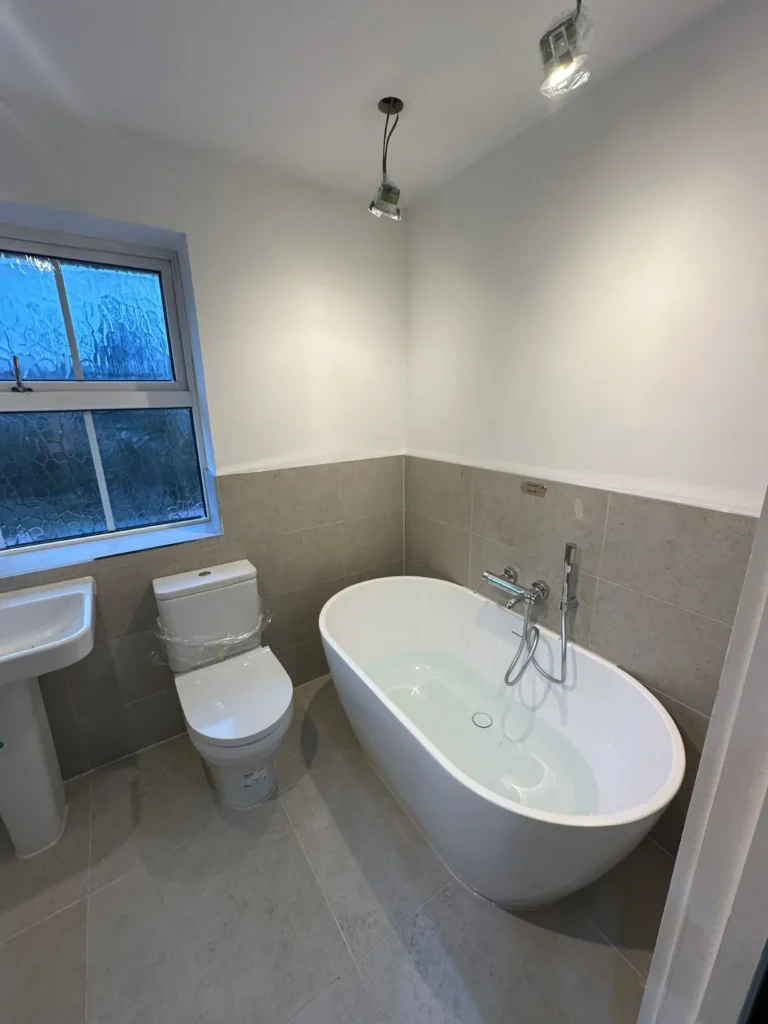 Contemporary bathroom refurbishment with freestanding bathtub and modern sanitary fittings.
