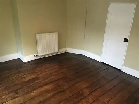 Newly installed wooden flooring in a refurbished residential room.