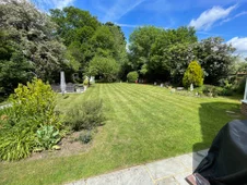 Beautiful landscaped garden with healthy green lawn and mature trees in Slough.