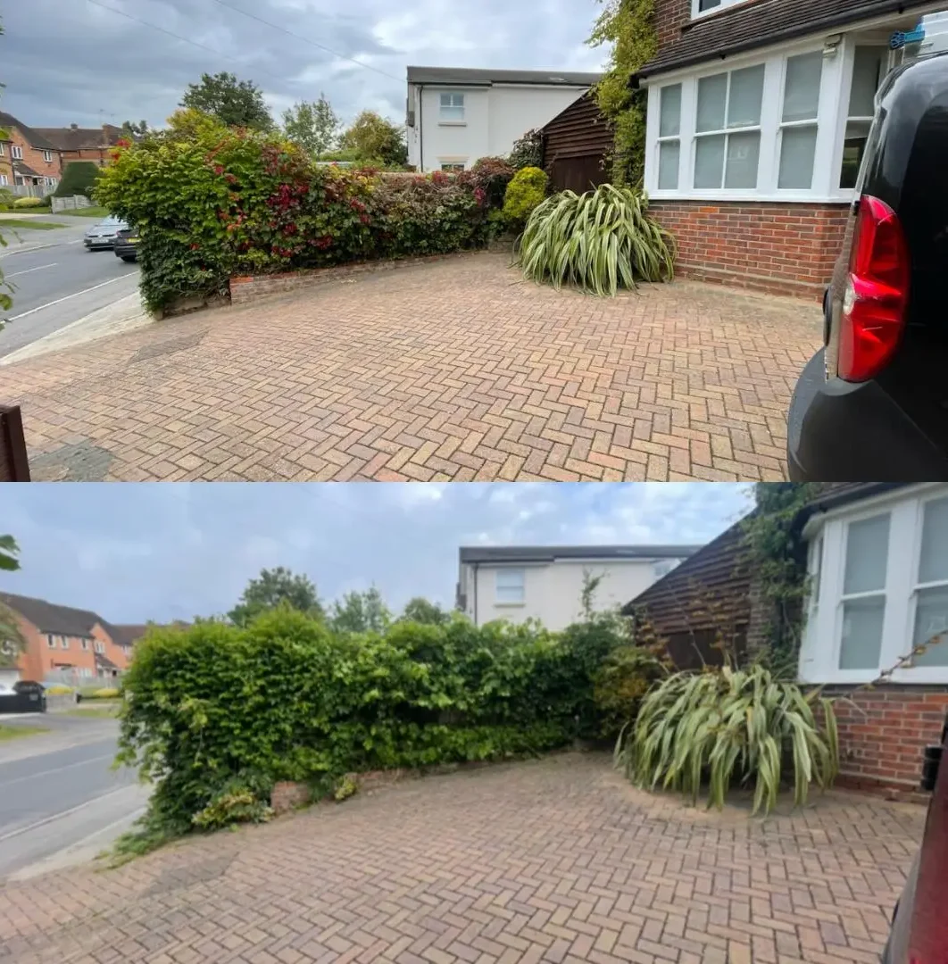 Block paved driveway and patio entrance surrounded by manicured shrubs and residential home front