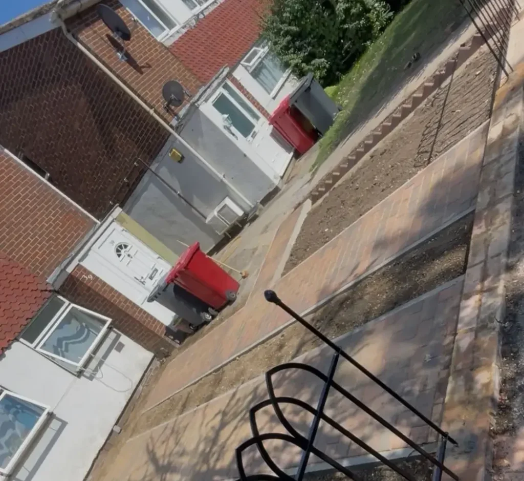 Ongoing hard landscaping and garden pathway layout work in a residential back garden.